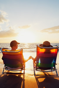 Couple in beach chairs watching sunset